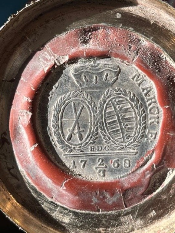 Saxon coin of 1768 set in red wax in the base of a bottle, crossed swords and arms under an electoral crown