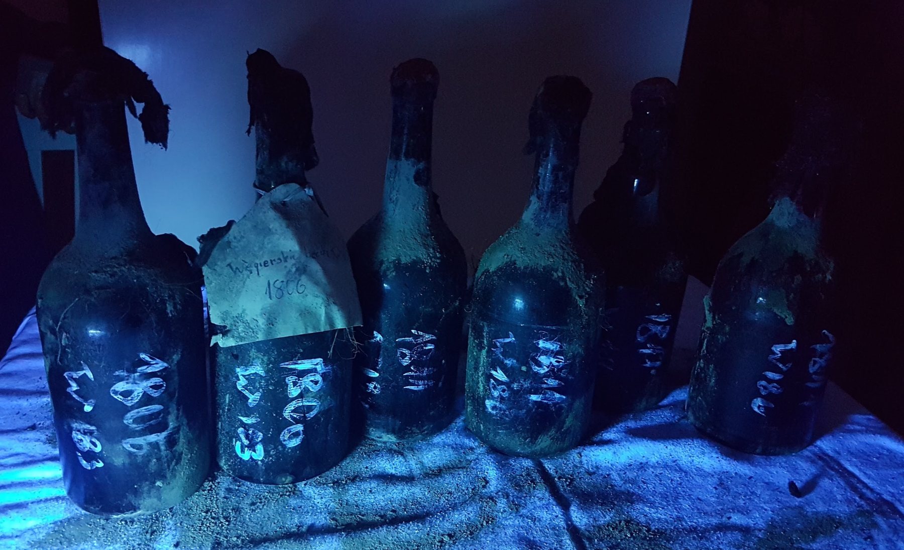 Six bottles under ultraviolet light