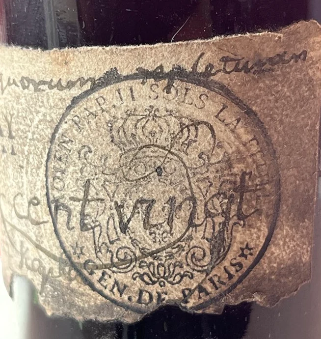 Close detail of the stamp on coarse laid paper, MOIEN PAR II SOLS LA FEUILLE · GEN. DE PARIS, with the word “cent vingt” written over it