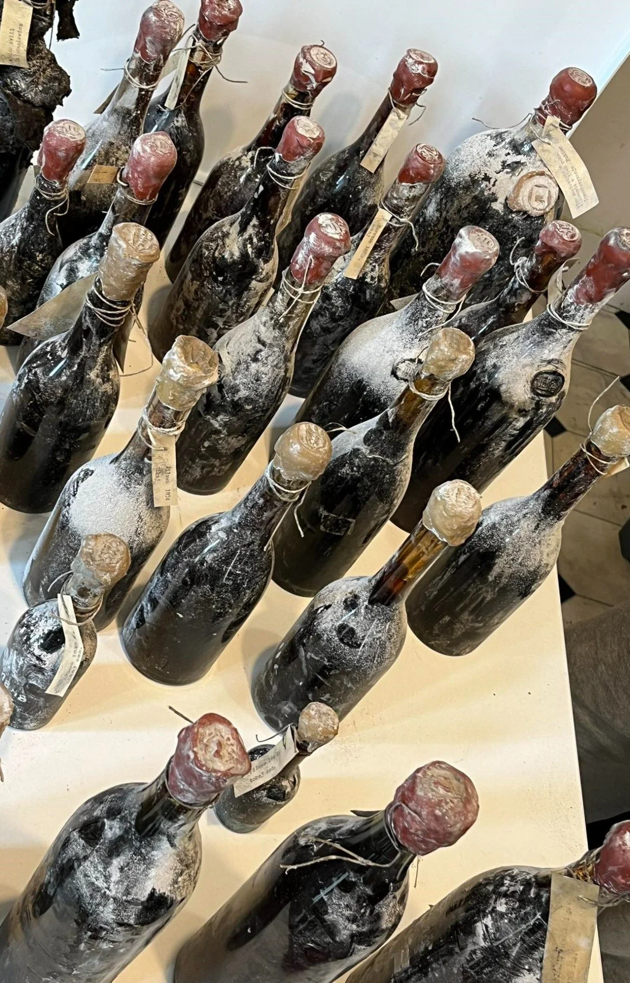 Very old Tokaji bottles, wax-capped and tagged, laid out for examination