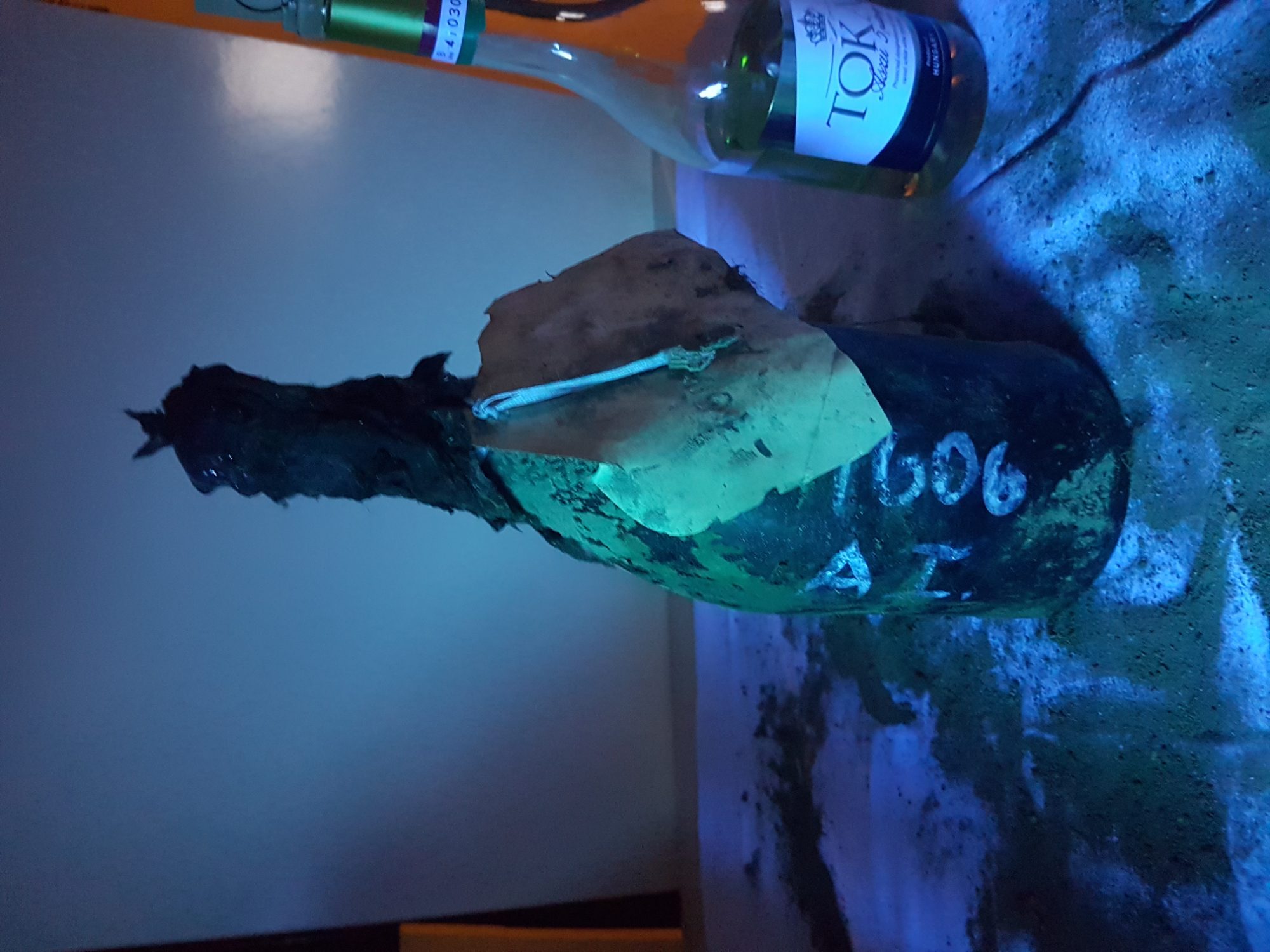 The base and mouth of the bottle in the hand
