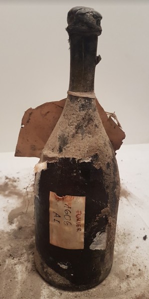 The bottle under UV light beside a modern Tokaji bottle