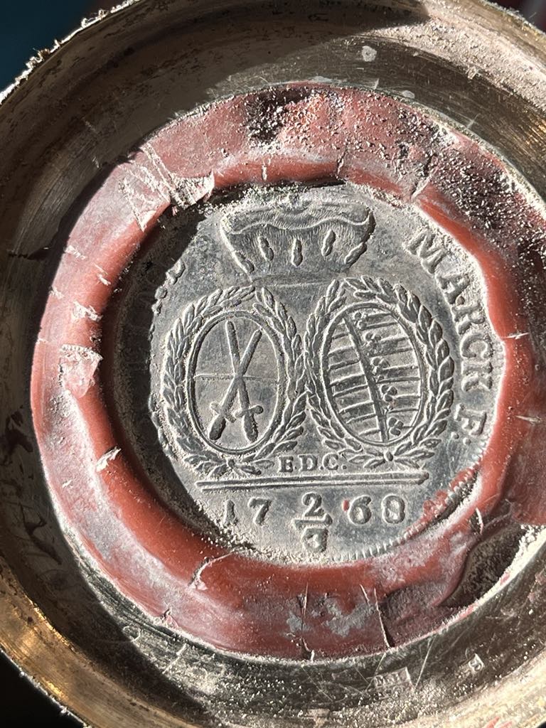 A 1768 Saxon thaler waxed into the underside of the silver foot