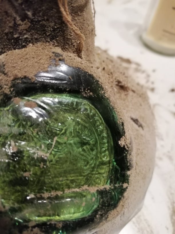 The applied green glass seal on the shoulder of bottle no. 3