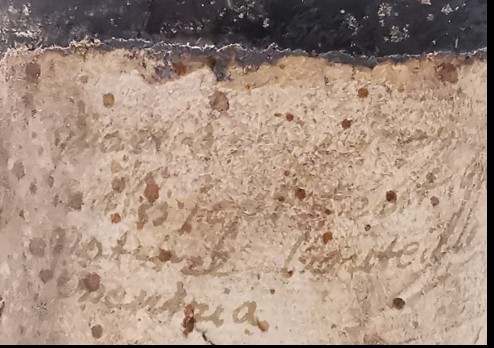 The handwritten paper label, largely obscured by cellar deposit