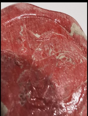 The crown of the wax capsule, showing the worn impression