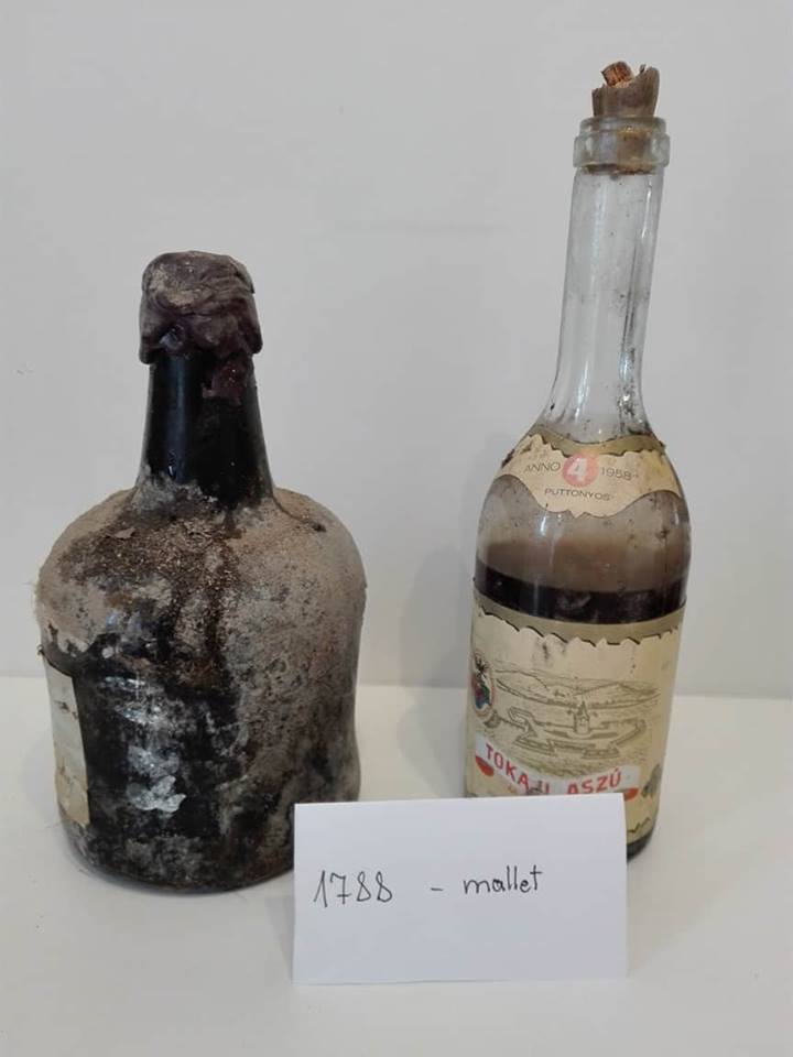 The wax-sealed cork under a thick misshapen capsule
