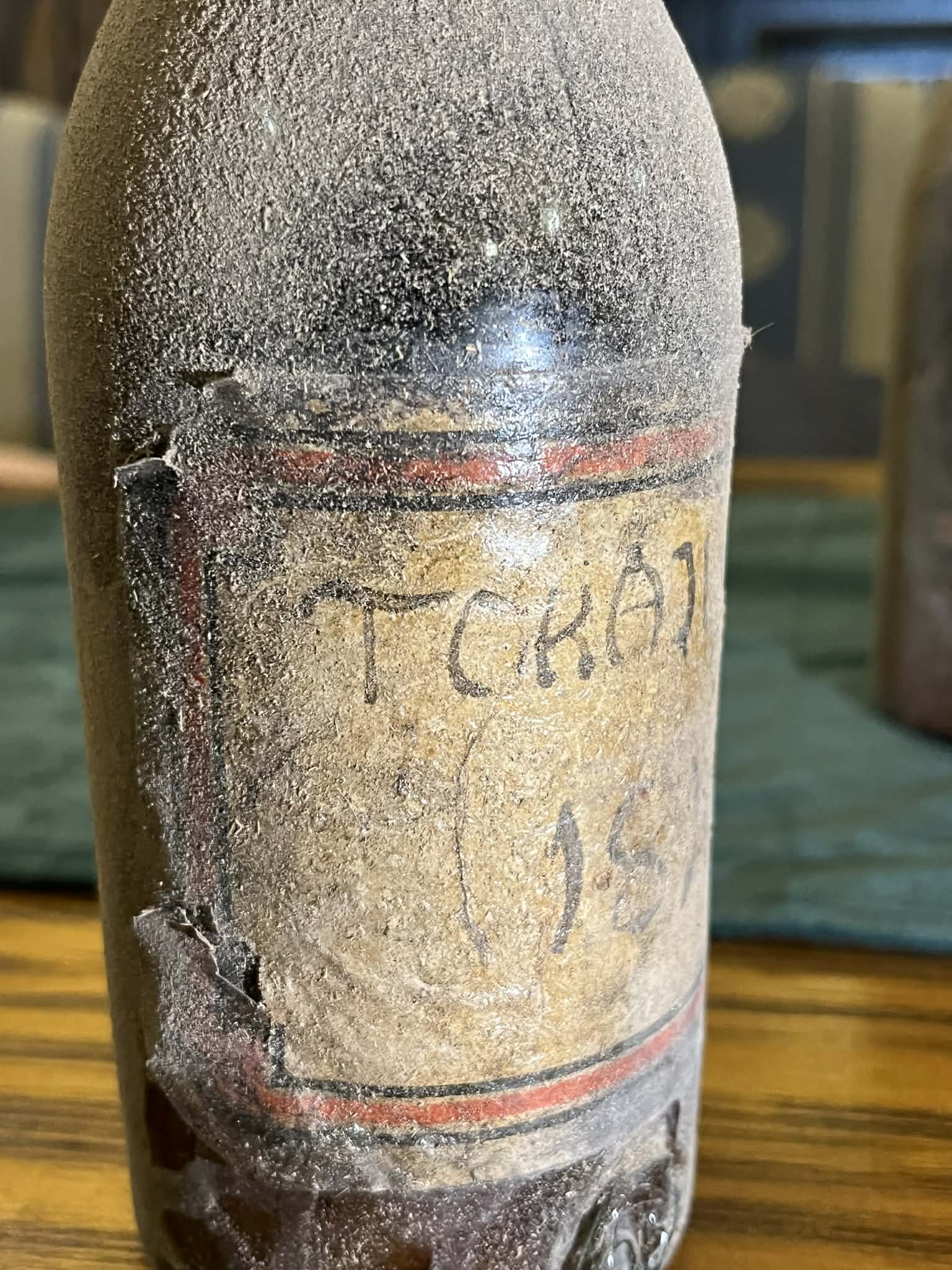 The bottle with its painted label reading TOKAJI ASZÚ 1811 between red and black rules