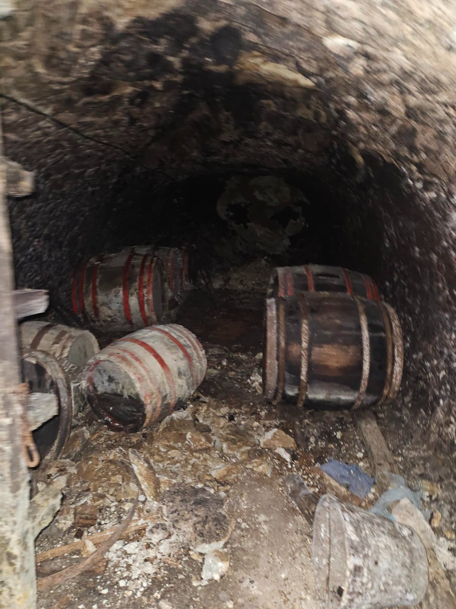 Small red-hooped barrels in a collapsed cellar niche