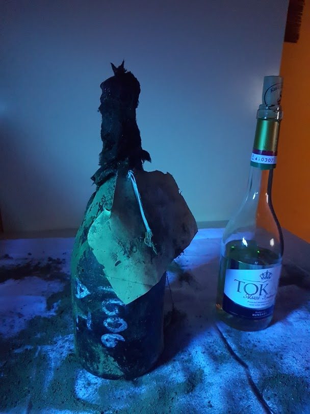 A 1606 bottle beside a modern bottle of Tokaji for scale