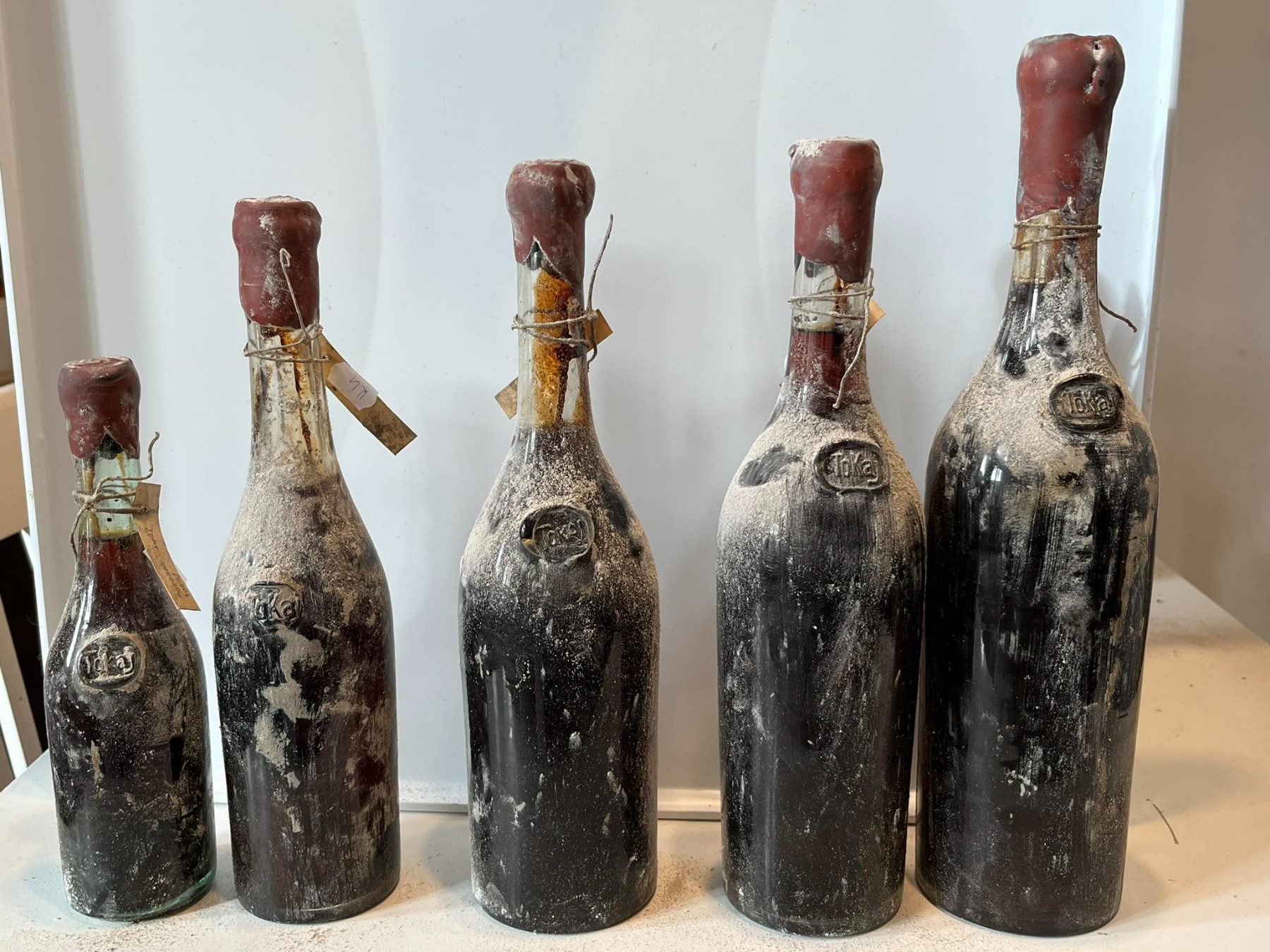 Five very old bottles with Tokaj glass seals