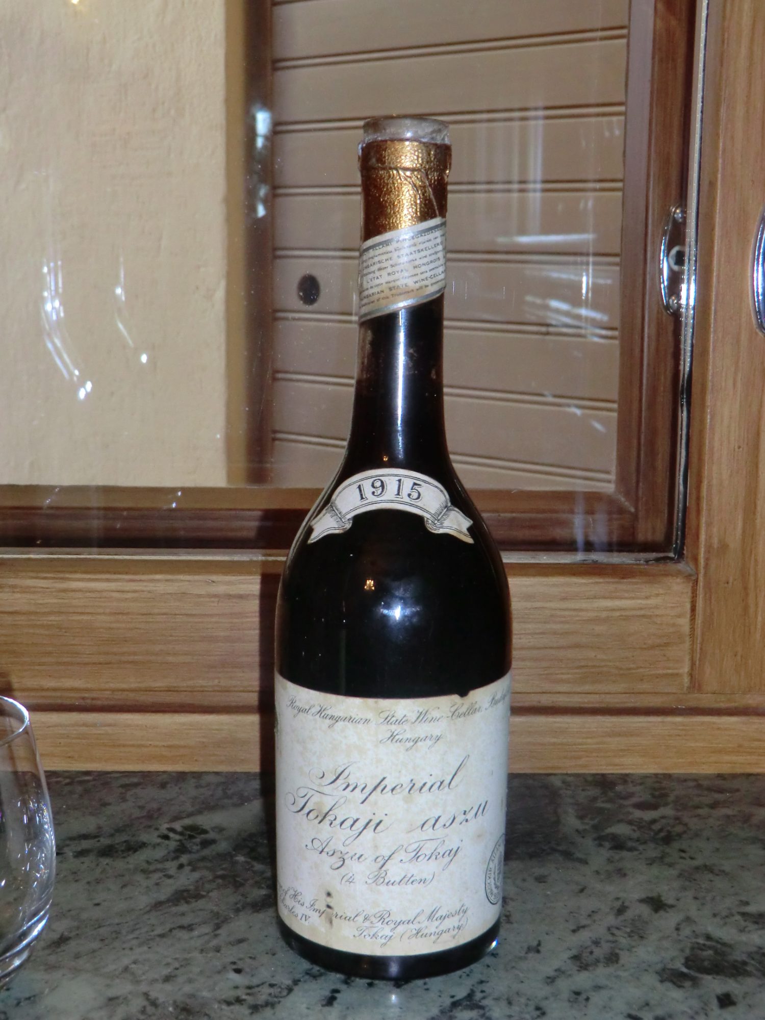 1915 bottle labelled Imperial Tokaji aszu, Royal Hungarian State Wine-Cellar, purveyor to His Imperial and Royal Majesty Charles IV