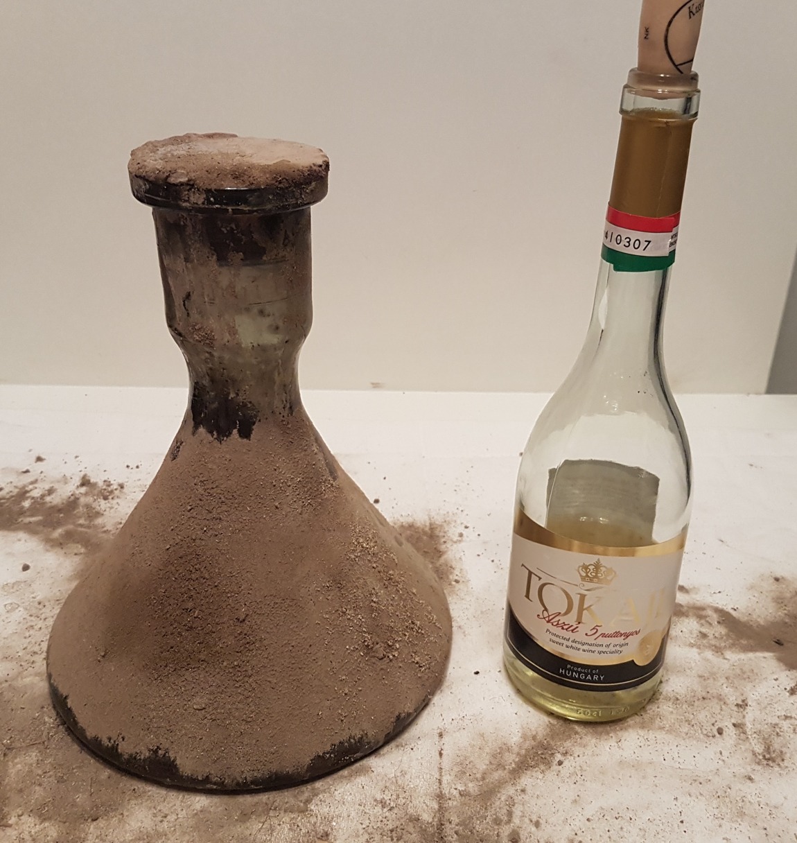 The unknown conical bottle beside a modern 5 puttonyos Tokaji bottle