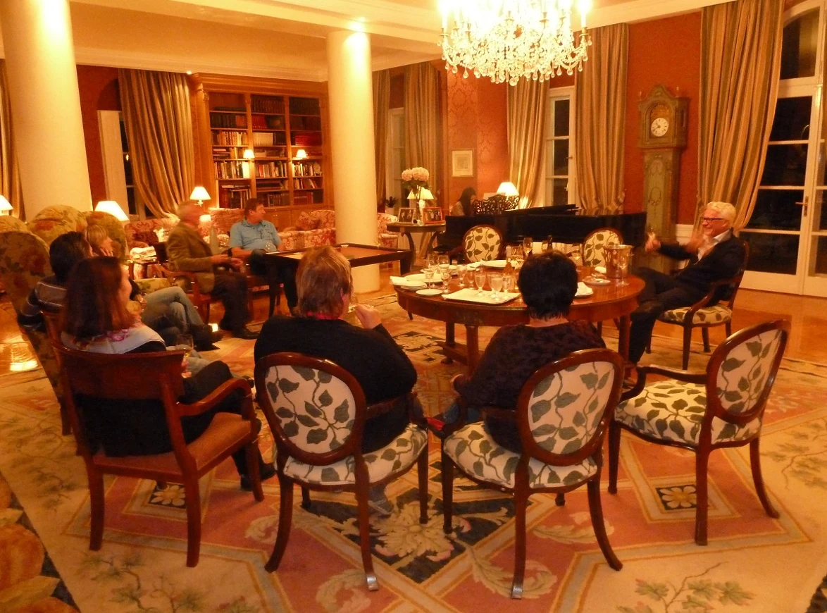 A tasting presentation in a salon, guests seated around the table