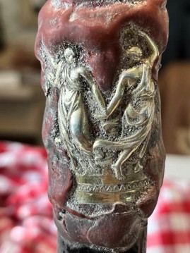 The silver capsule, two gilded dancing figures over a patterned band