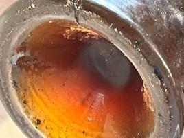 The wine seen through the neck of the bottle