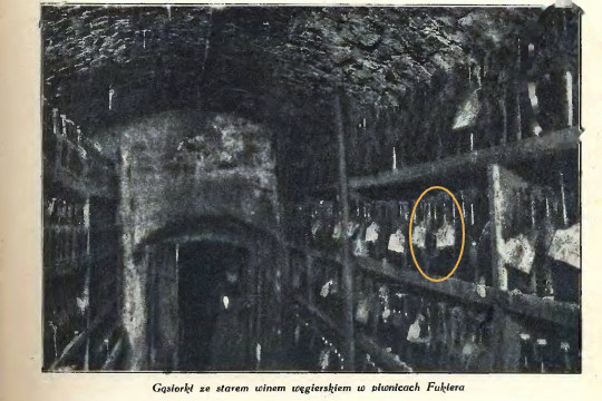The Fukier cellar, bottles racked with paper tags on their necks; one tagged bottle marked