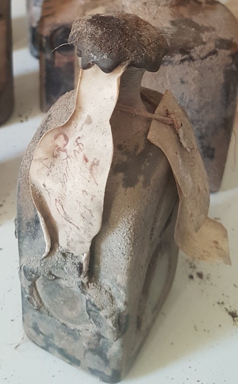 The 1668 bottle, coins set into the glass of the body