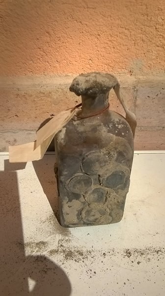 The bottle upright, seal and paper strip in place